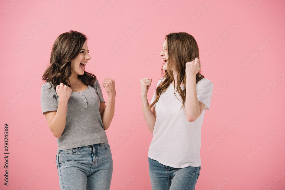 attractive and smiling women in t-shirts showing yes gestures isolated on pink attractive and smiling women in t-shirts showing yes gestures isolated on pink