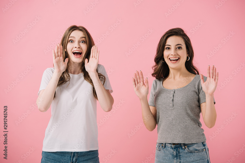attractive and smiling women in t-shirts looking at camera isolated on pink attractive and smiling women in t-shirts looking at camera isolated on pink