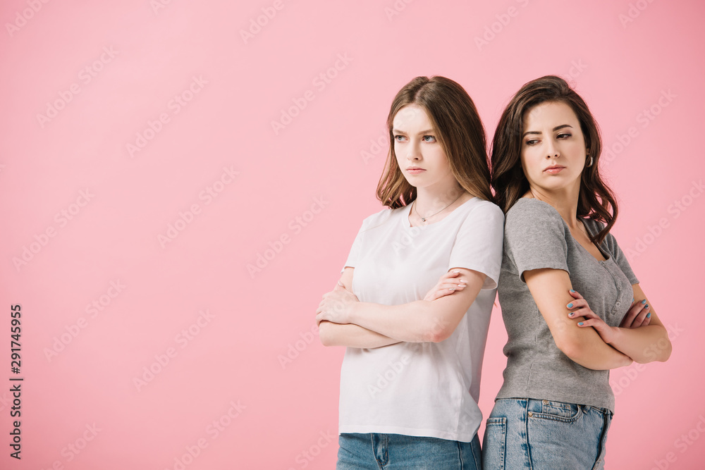 attractive and sad women in t-shirts with crossed arms looking away isolated on pink attractive and sad women in t-shirts with crossed arms looking away isolated on pink