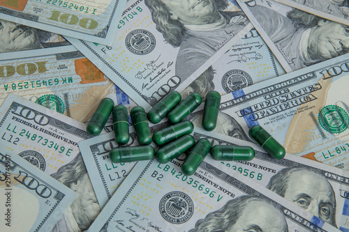 Medicine capsules on dollars for pharmaceutical industry concept of high cost for healthcare and medication