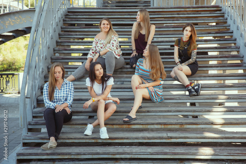 Fototapeta Naklejka Na Ścianę i Meble -  Different and happy in their bodies. Young women smiling, talking, walking and having fun together outdoors on sunny summer's day at park. Girl power, feminism, women's rights, friendship concept.