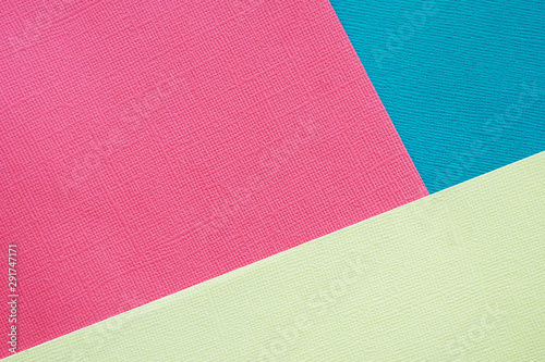 Abstract background and texture. Three sheets of multi-colored pink, blue and light yellow texture paper...