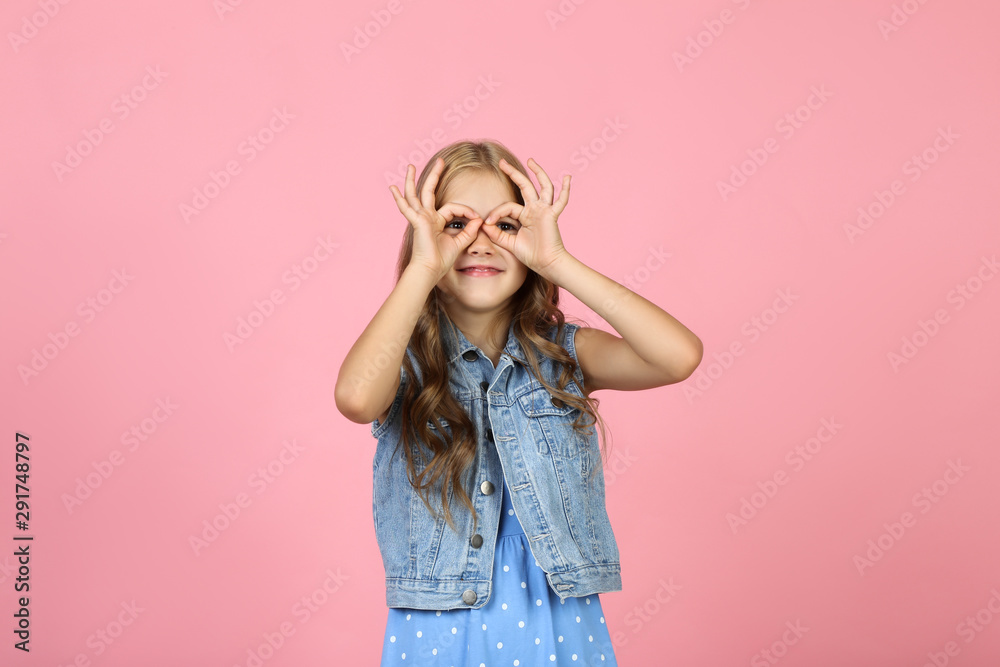 Pretty little girl on pink background