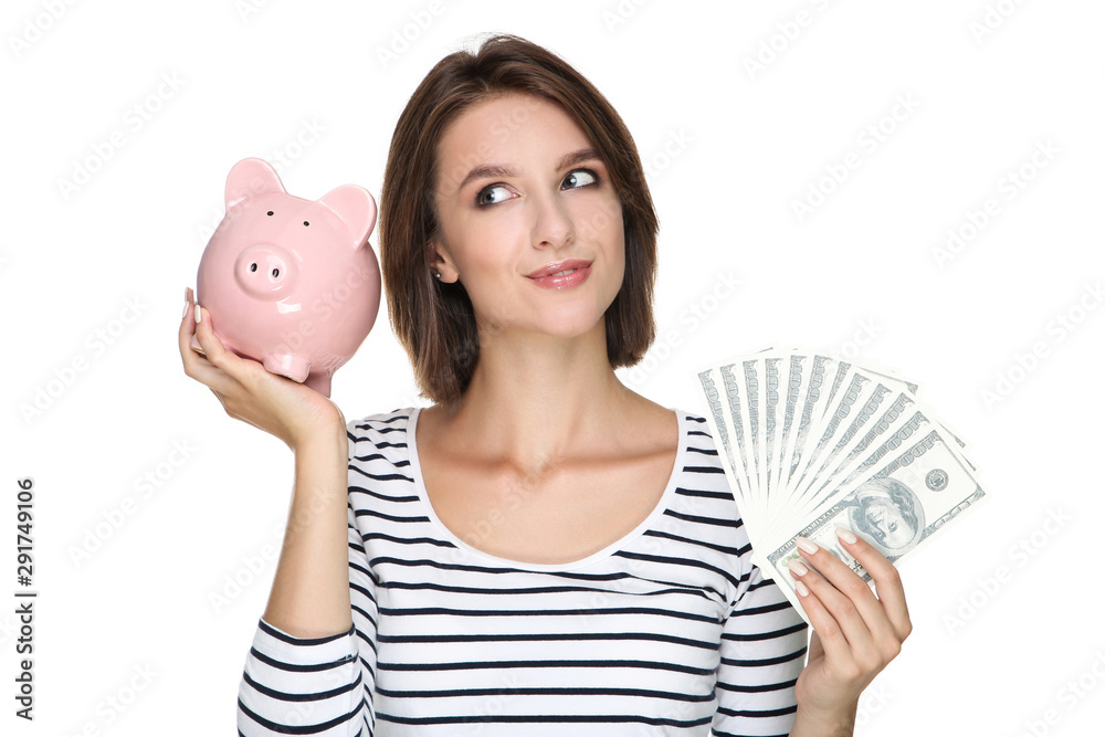 Φωτογραφία Young woman holding dollar banknotes and pink piggybank on white background