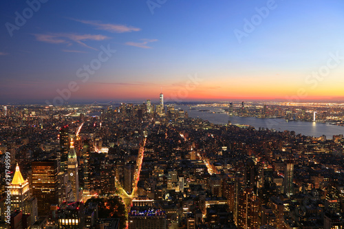 Aerial view of New York City, Lower Manhattan skyline illuminated at sunset, USA