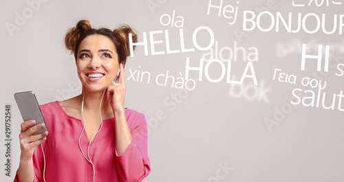 Woman with cellphone hearing different languages on grey