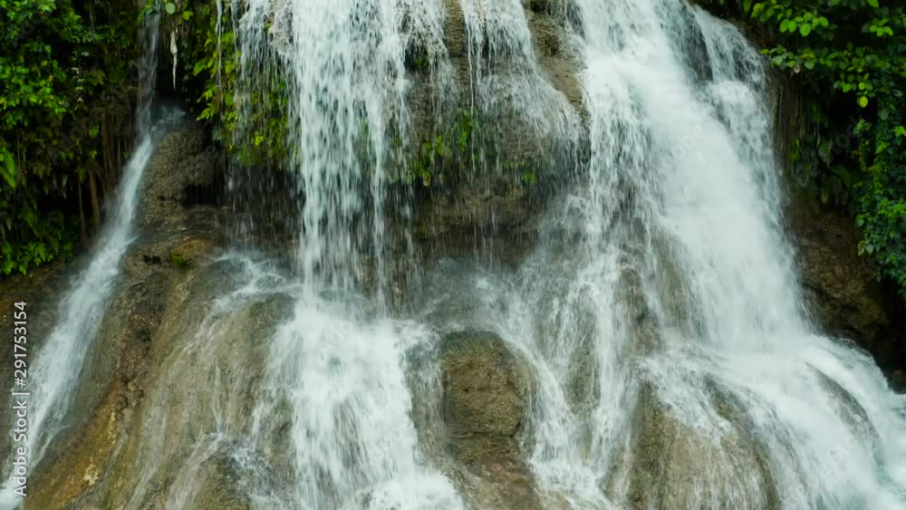 Beautiful waterfall in green forest, top view. Tropical Lusno falls in mountain jungle, Philippines, Cebu. Waterfall in the tropical forest. Beautiful waterfall in green forest, top view. Tropical Lusno falls in mountain jungle, Philippines, Cebu. Waterfall in the tropical forest.