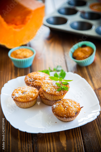 baked sweet pumpkin muffins with dried apricots inside,