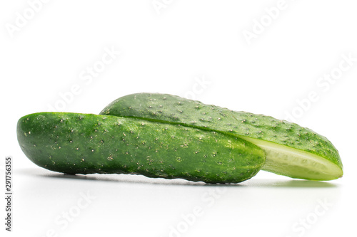 Group of two halves of fresh pickling cucumber one sliced isolated on white background