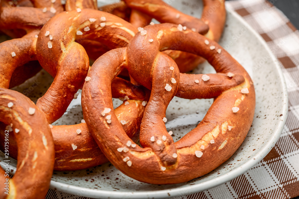 Fresh bavarian pretzels on a wooden table, pretzel with salt Fresh bavarian pretzels on a wooden table, pretzel with salt