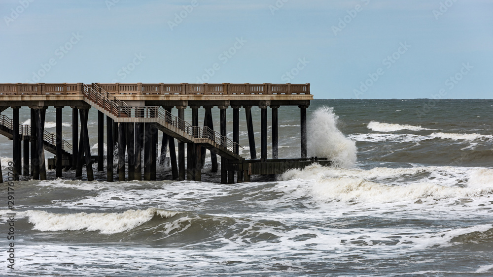 Big stormy waves crash on the pier