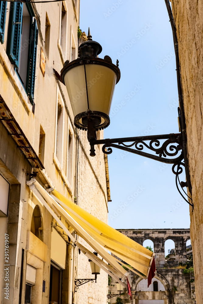 Lantern in the narrow city street in old town in Split, Dalmatia