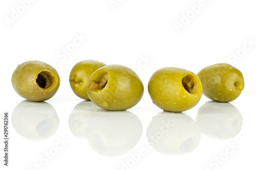 Group of five whole pitted green olive isolated on white background