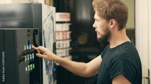 Young Man Buying Coffee Vending Machine