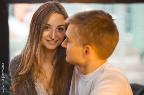 loving couple in a cozy room posing for the camera
