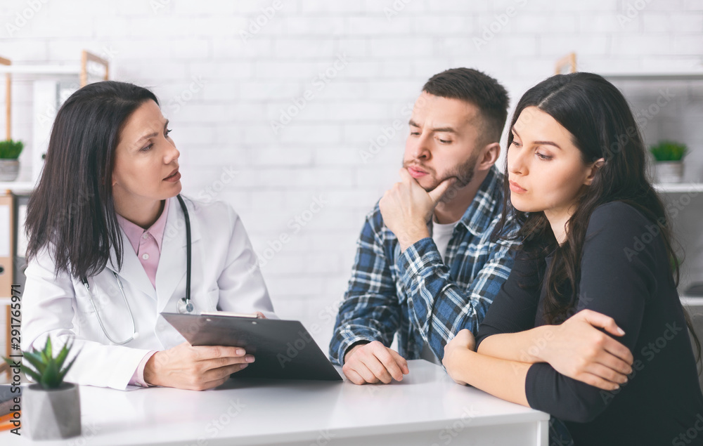 Young man and woman reading doctor's prescriptions for infertility cure Young man and woman reading doctor's prescriptions for infertility cure