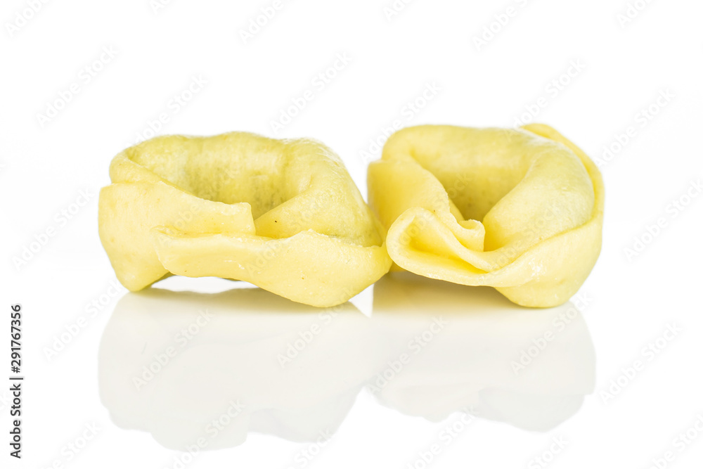 Group of two whole fresh yellow spinach filled tortelloni isolated on white background Group of two whole fresh yellow spinach filled tortelloni isolated on white background