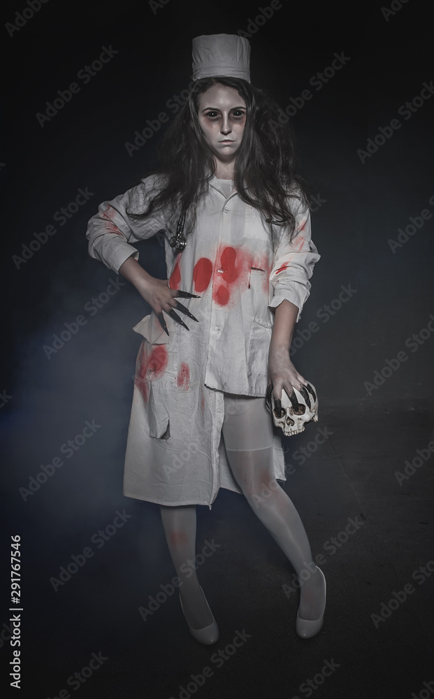Terrible nurse woman and skull. Halloween horror scene Terrible nurse woman and skull. Halloween horror scene