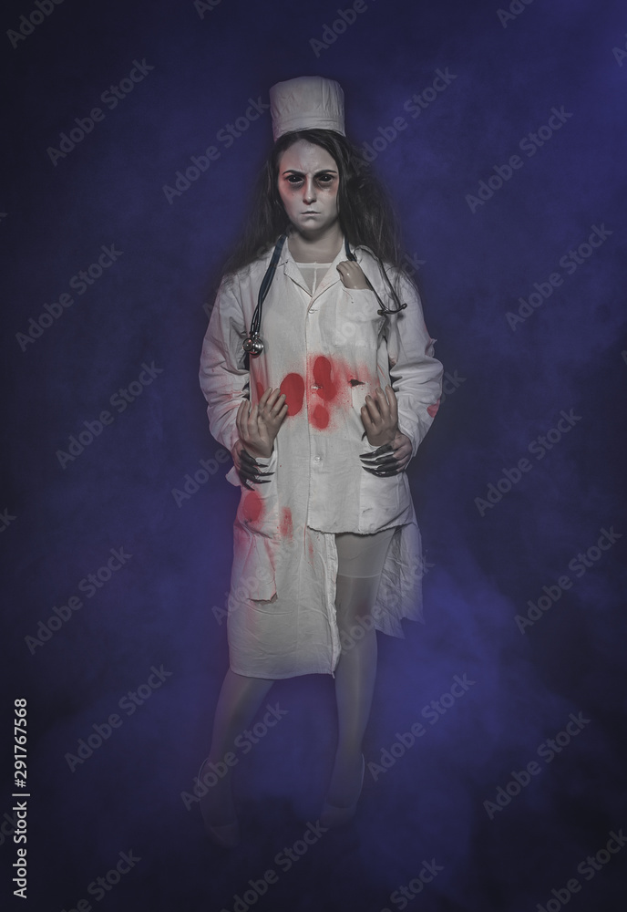 Terrible nurse woman in bloody robe. Halloween scene Terrible nurse woman in bloody robe. Halloween scene