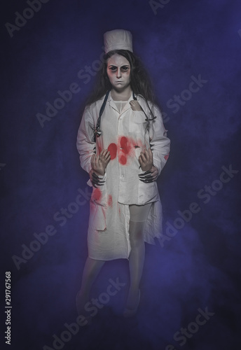 Terrible nurse woman in bloody robe. Halloween scene
