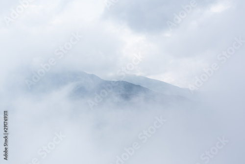 Mountain through clouds