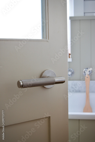 Stainless steel door handle on bathroom door