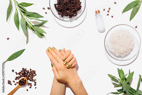 Woman's hands with green manicure among natural ingredients