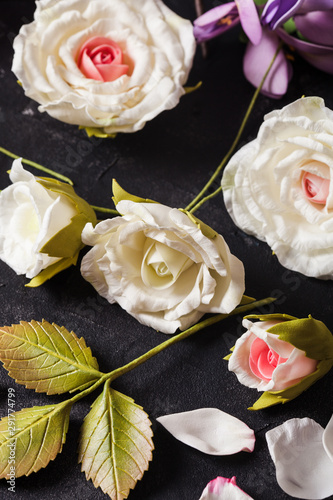 Various handmade flowers from foamiran foam on the table photo