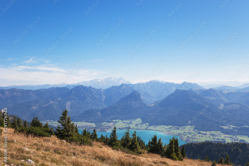 Idyllic shot of mountains and Lake Wolfgangsee against blue sky Idyllic shot of mountains and Lake Wolfgangsee against blue sky