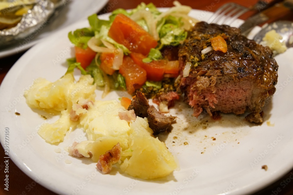 Grilled steak medium rare with potatoes and salad