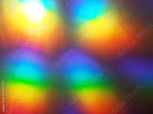 Rainbow abstract glowing light colorful defocused background.