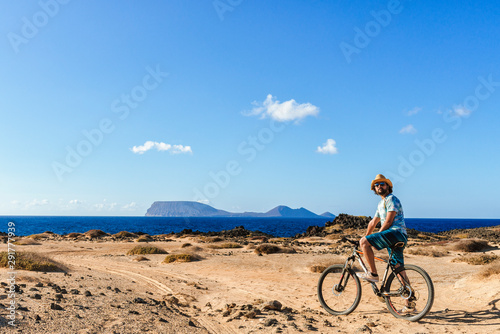 Man on a bicycle, La Graciosa island, Lanzarote, Canary Islands, Spain