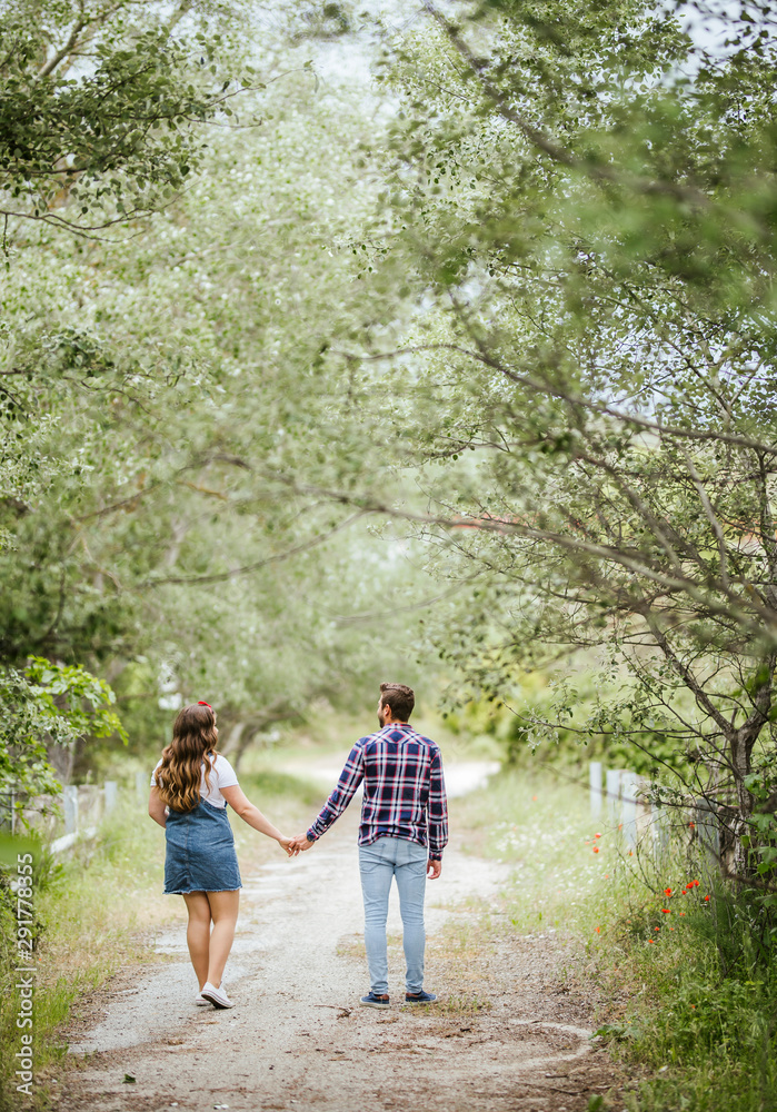 Young couple going for a walk holding hands Young couple going for a walk holding hands