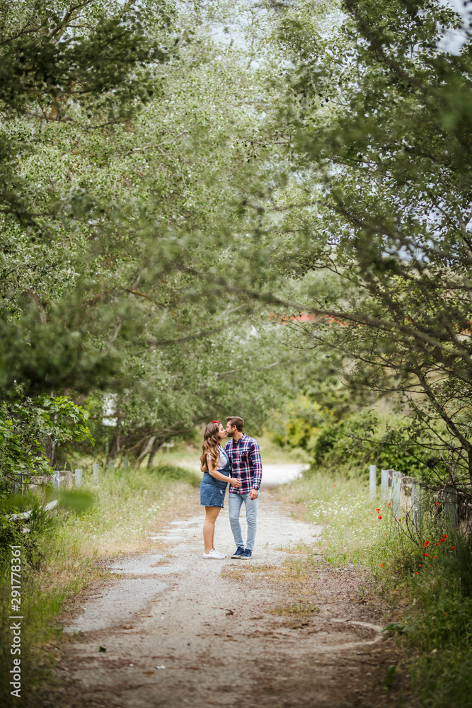 Young couple kissing on a path Young couple kissing on a path