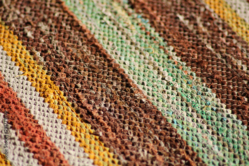 Colorful carpet made of rags, striped pattern detail