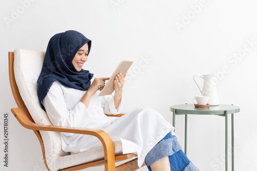 Young Muslim women Students is a creative freelance journalist sit writing to be entrepreneur job concept for hijab girl Islam religion Asian ethnic joyful internet banking on tablet mobile smartphone photo