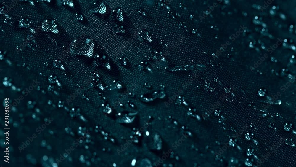 Super slow motion of falling water drops on waterproof cloth texture in detail. Filmed on high speed cinema camera, 1000 fps.