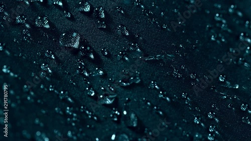 Super slow motion of falling water drops on waterproof cloth texture in detail. Filmed on high speed cinema camera, 1000 fps.