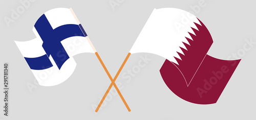 Crossed and waving flags of Finland and Qatar
