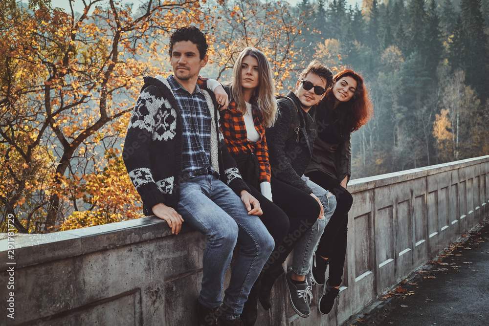 Best friends are posing for photographer while walking in autumn forest. Best friends are posing for photographer while walking in autumn forest.