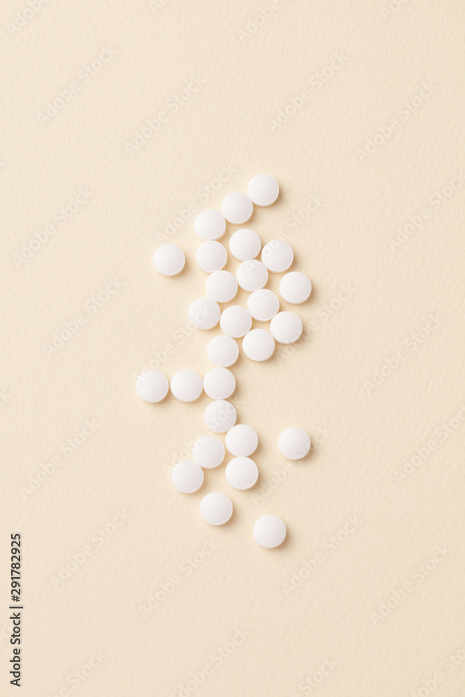 Biotin Tablets. Bright paper background. Top view. Copy space. Biotin Tablets. Bright paper background. Top view. Copy space.
