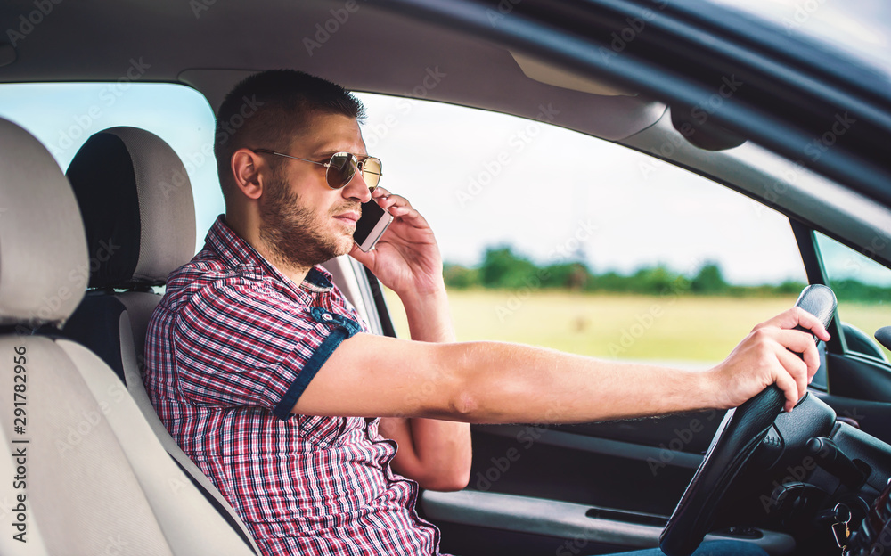 Man making a phone call while driving a car. Dangerous driving. Transportation concept