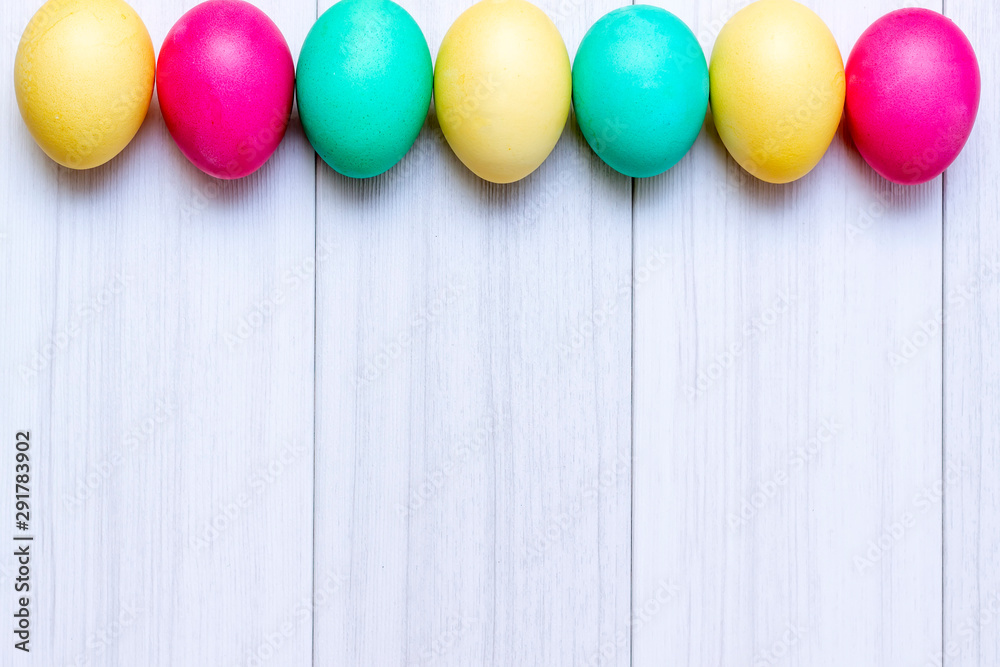Easter eggs painted in pastel colors on a white wooden background. Easter eggs painted in pastel colors on a white wooden background.
