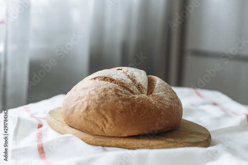 Loaf of bread on a board on a white tablecloth