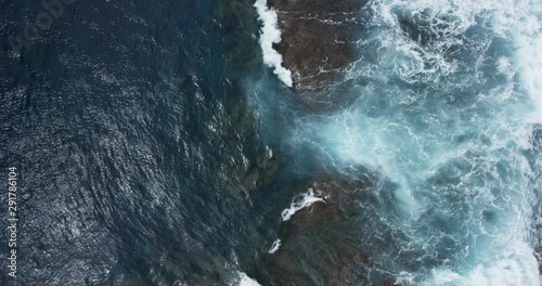 Overhead aerial, crashing ocean waves in Australia