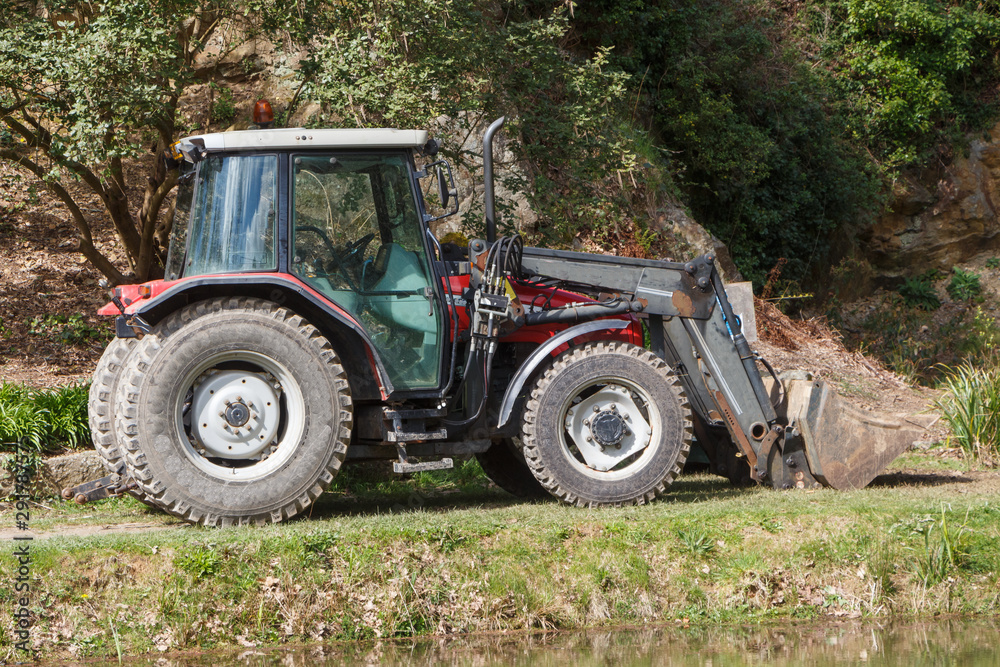 Tractor parked in the backyard of a farm Tractor parked in the backyard of a farm