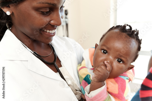 Closeup of an African female doctor holding an infant