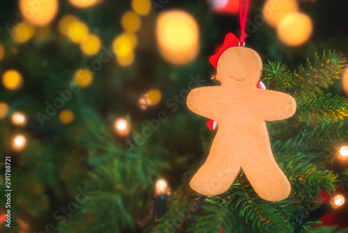 Gingerbread man hanging in Christmas tree. Xmas frame