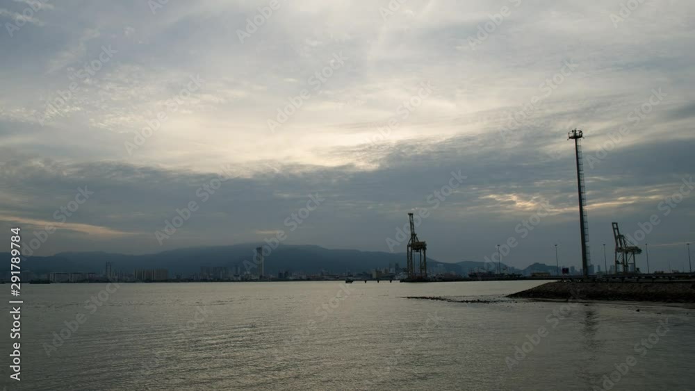 Timelapse busy Penang Port, Malaysia - North Butterworth Container Terminal (NBCT). With tallest building of Penang (KOMTAR) at the background. Timelapse busy Penang Port, Malaysia - North Butterworth Container Terminal (NBCT). With tallest building of Penang (KOMTAR) at the background.