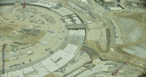 Helicopter aerial panning over round construction site, birds eye view, day photo